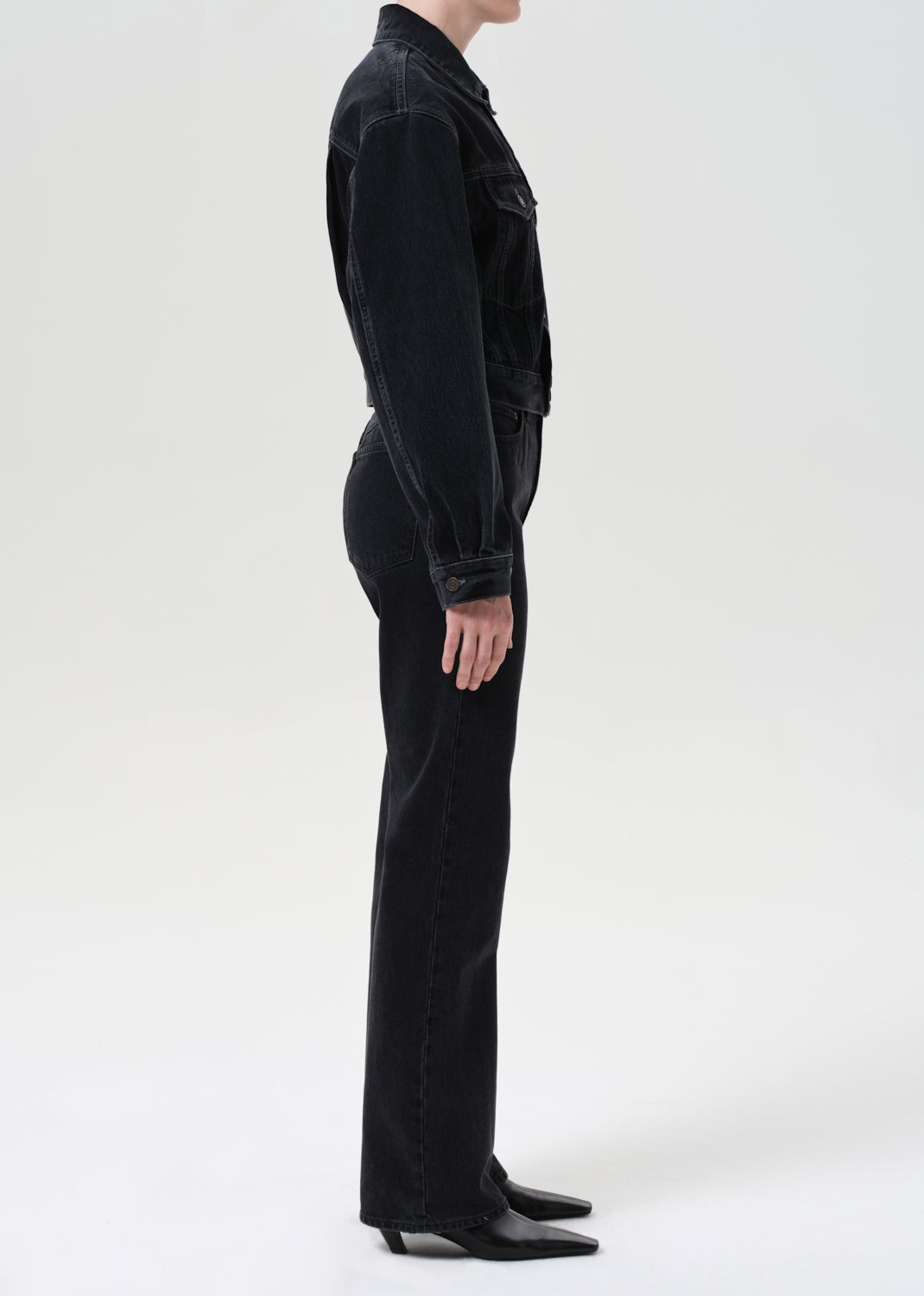 Person wearing a black outfit on a white background