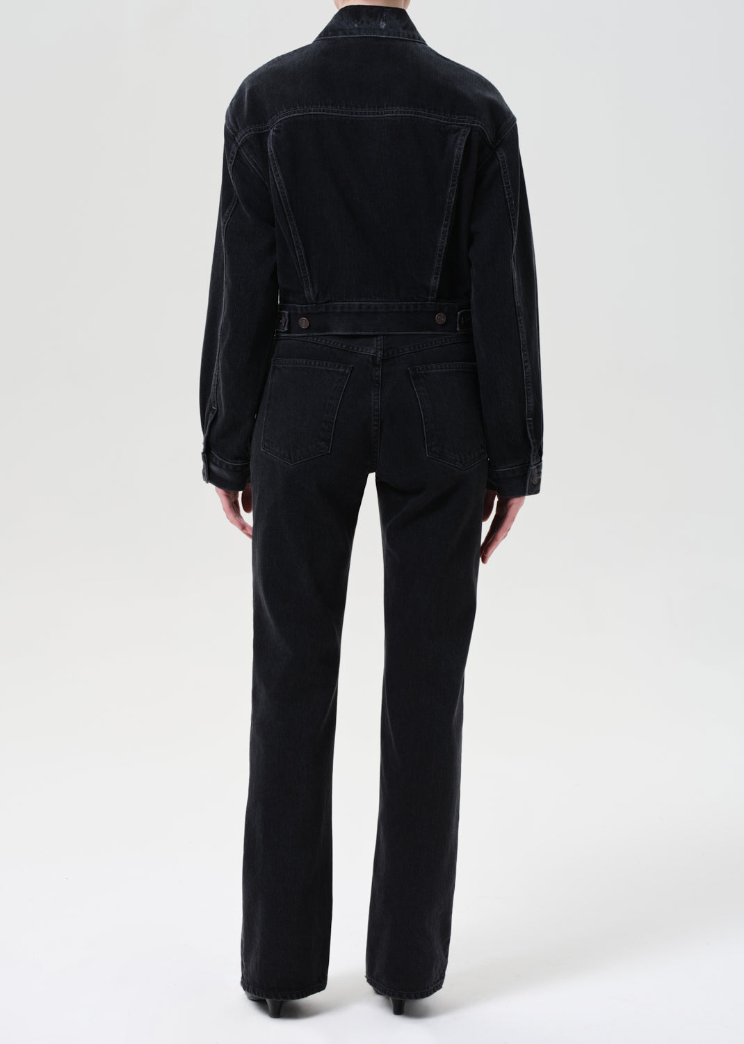 Black denim jumpsuit on a white background