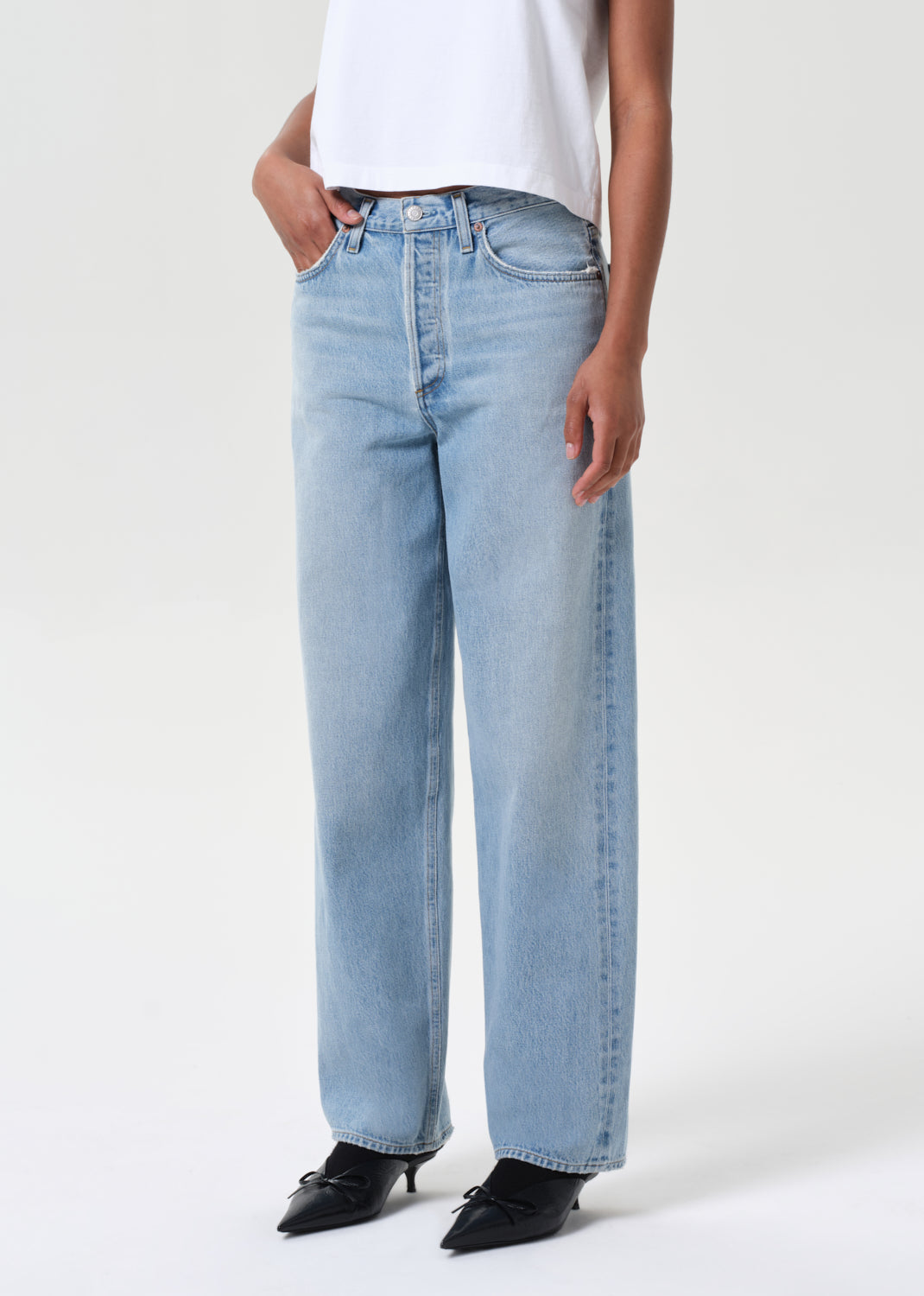 Light blue jeans worn by a person on a white background