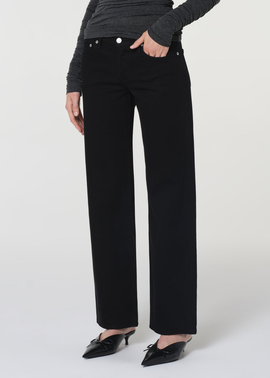 Person wearing black pants on a white background