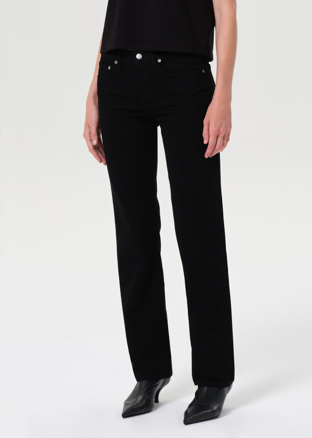 Person wearing black pants on a white background