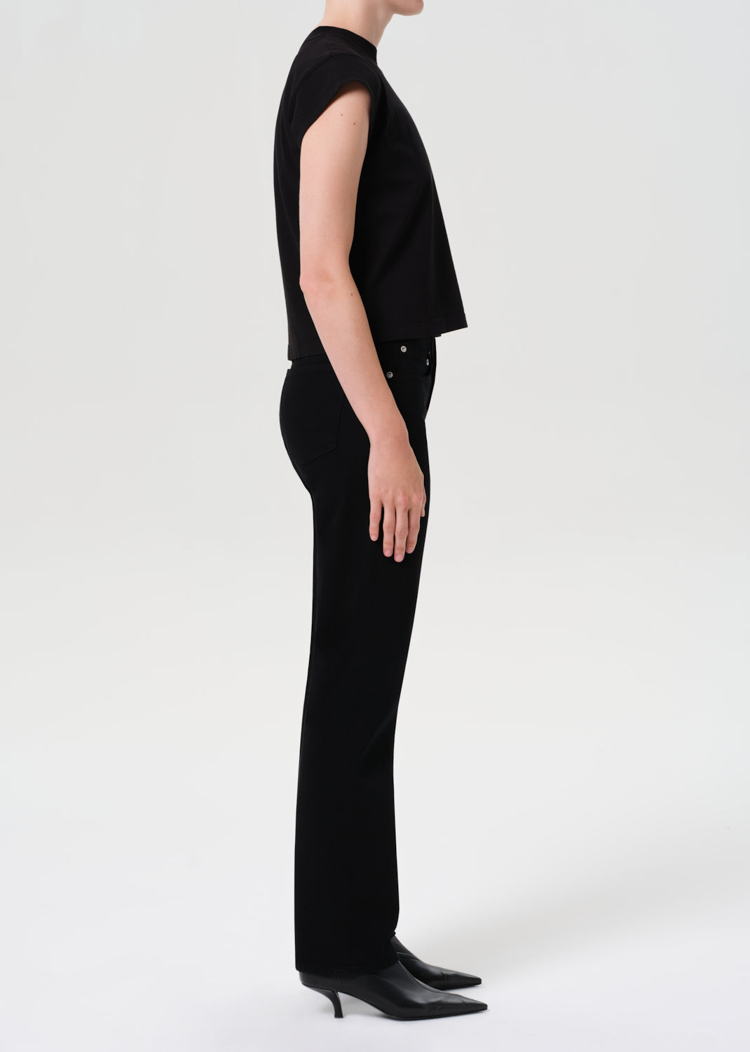 Person wearing a black outfit on a white background