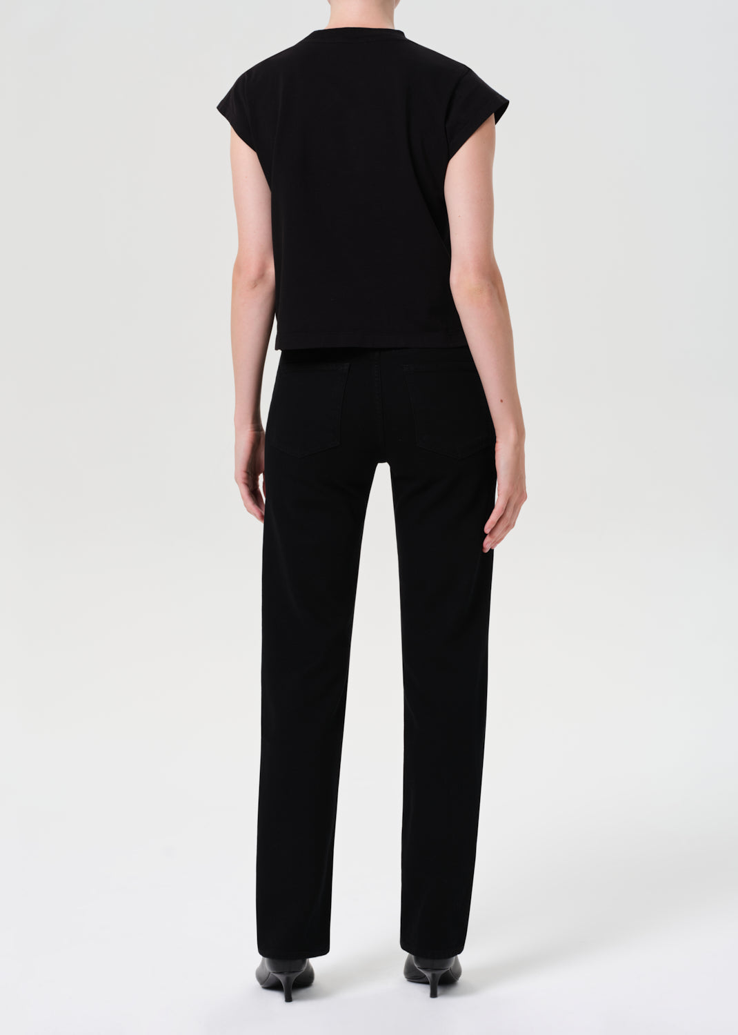 Person wearing a black outfit on a white background