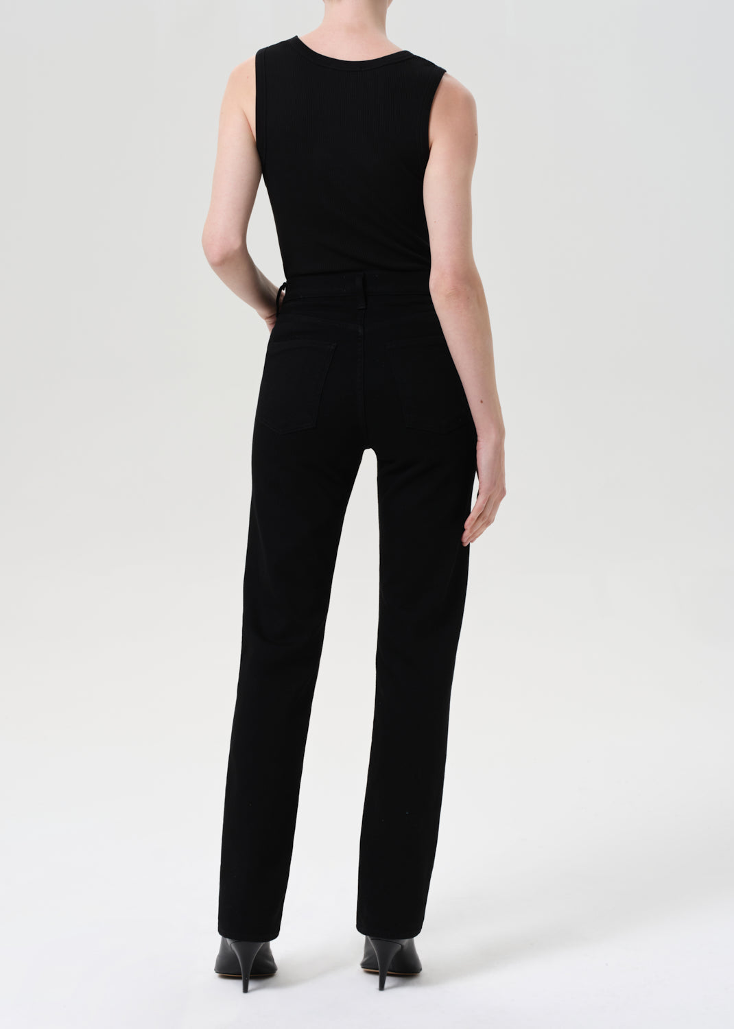 Black jumpsuit worn by a person on a white background