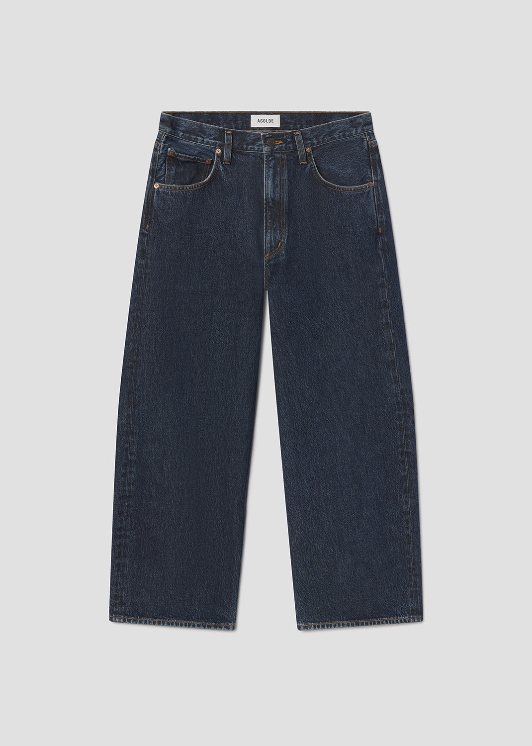 Pair of dark blue jeans on a light gray background