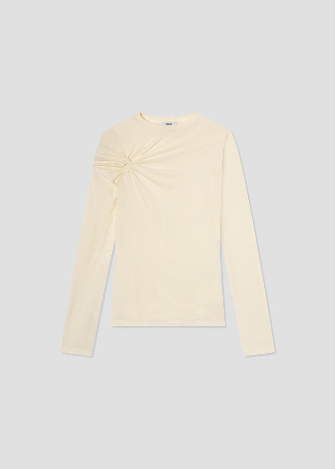 Cream-colored long-sleeve top with a twisted neckline on a light gray background