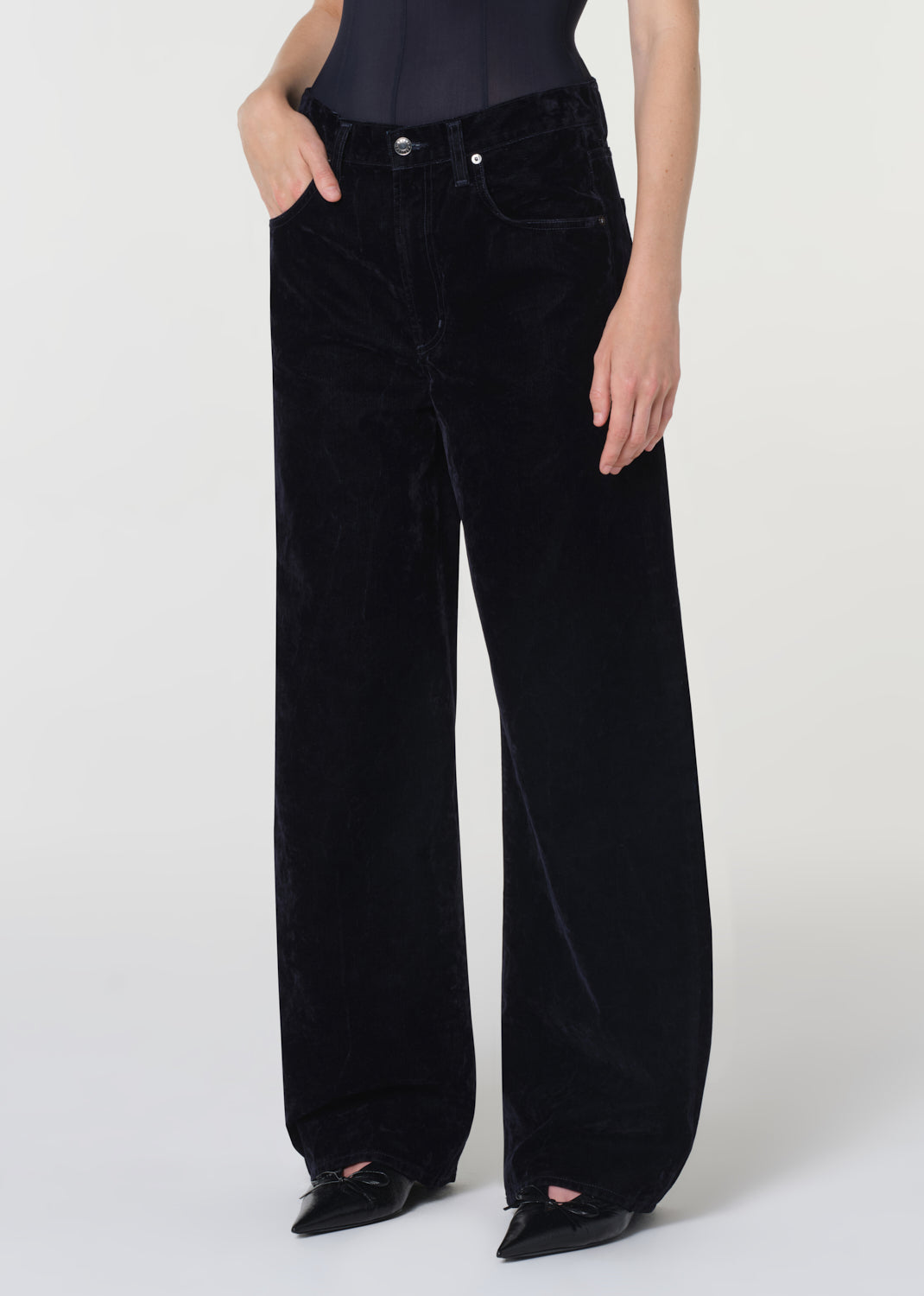 Blue velvet wide-leg pants worn by a person on a white background