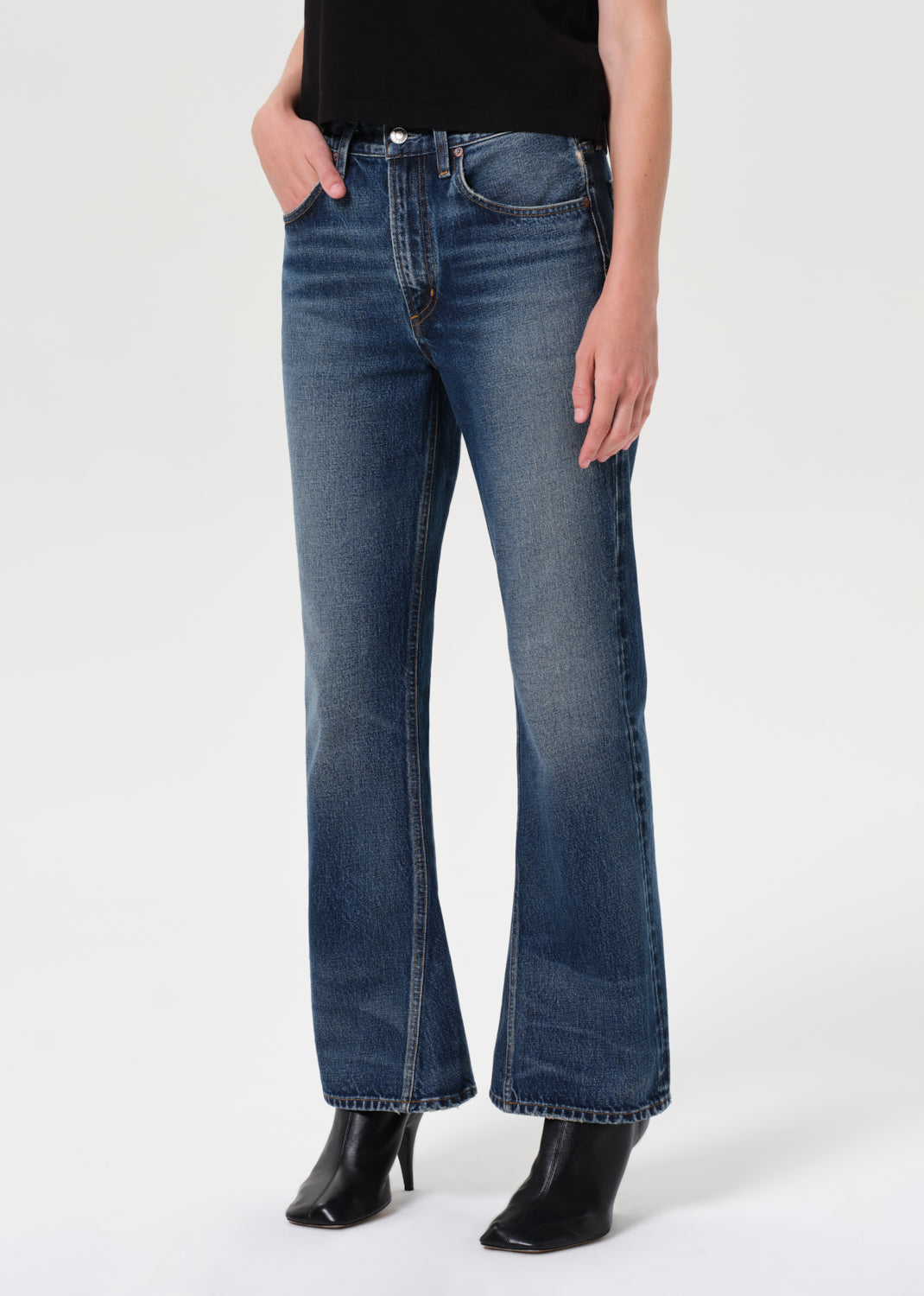 Person wearing blue jeans on a white background