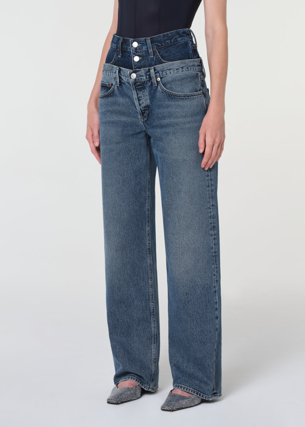 Person wearing blue jeans on a white background