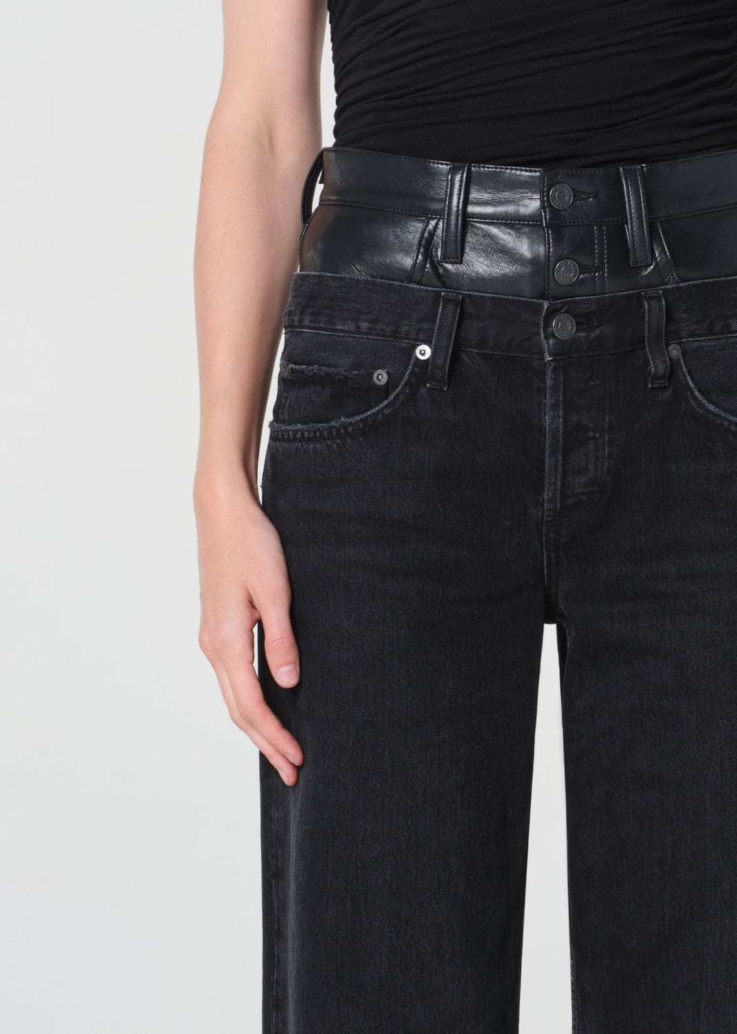 Black leather belt and jeans on a plain background