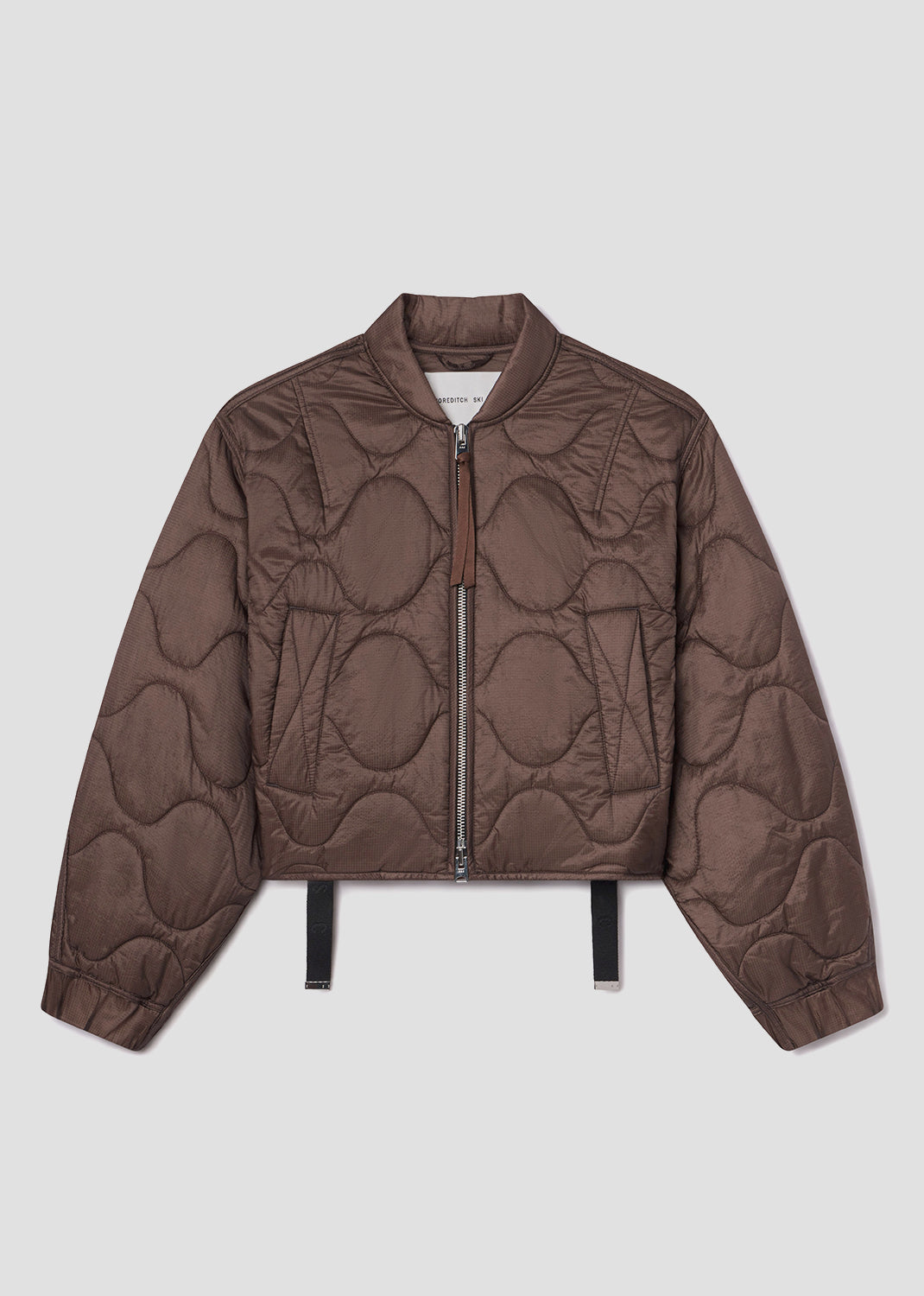 Brown quilted jacket on a light gray background
