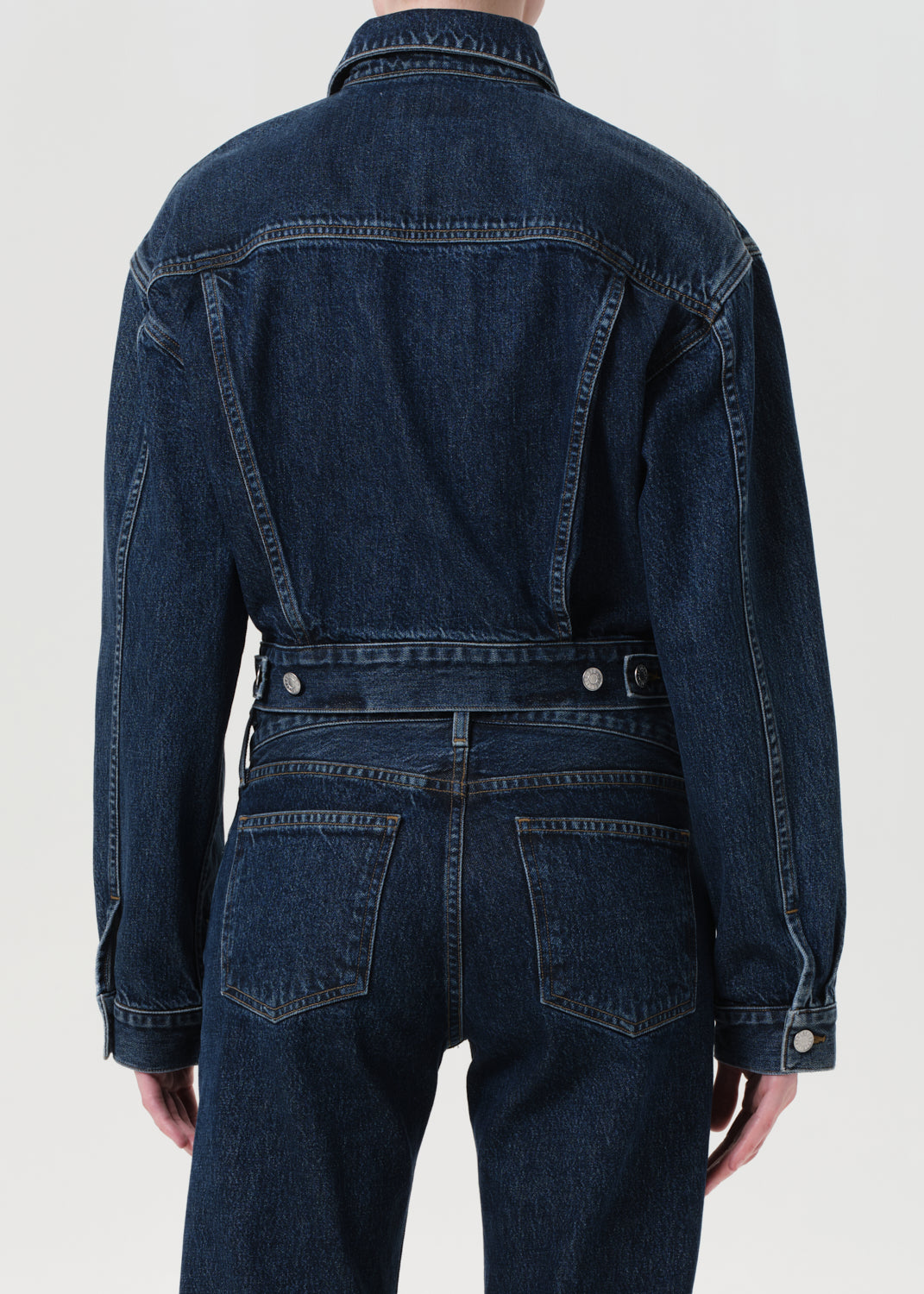 Dark blue denim jacket and pants on a white background