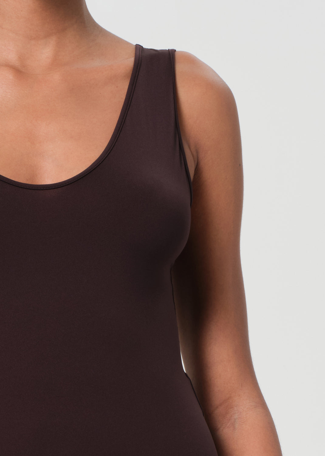 Brown tank top worn by a person on a light gray background