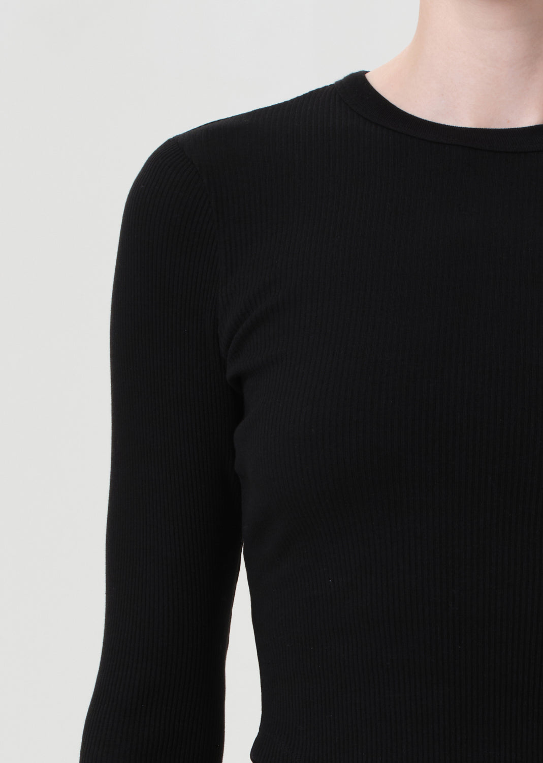 Black long-sleeve top on a plain background