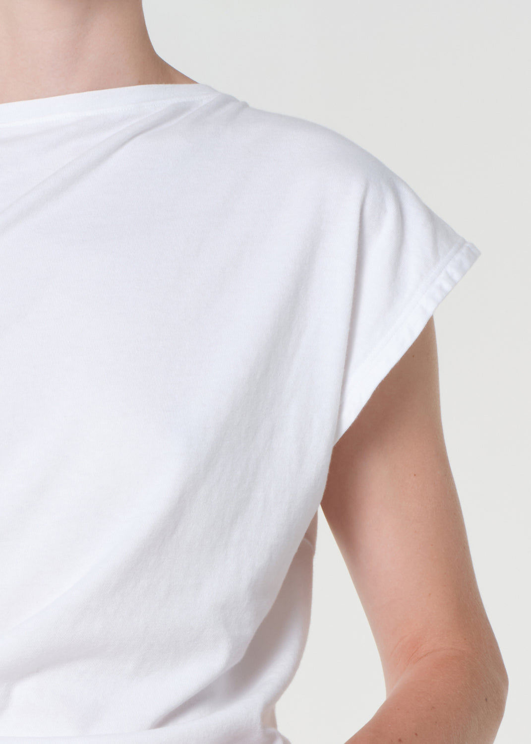 White t-shirt worn by a person on a plain background