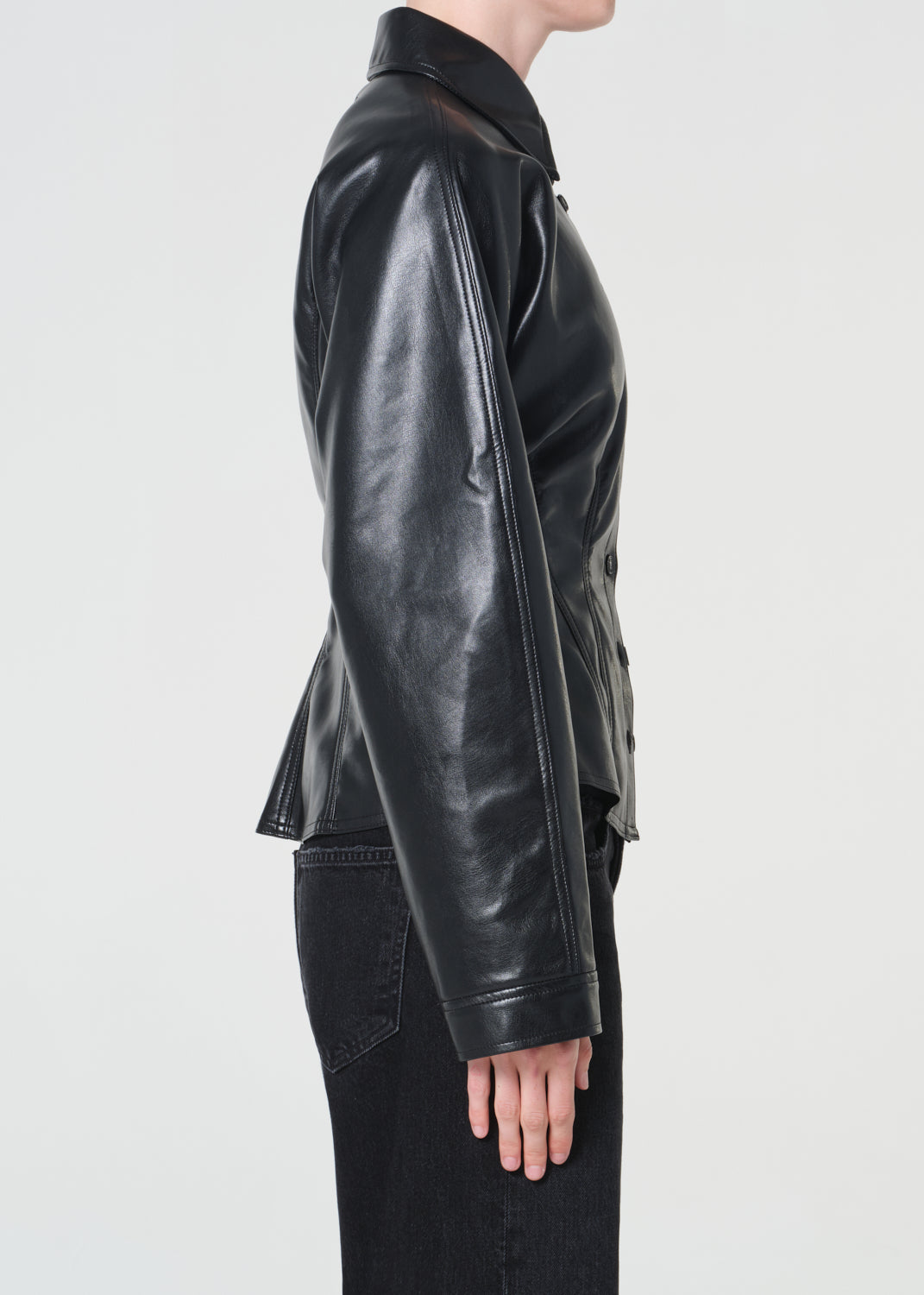 Black leather jacket worn by a person on a white background