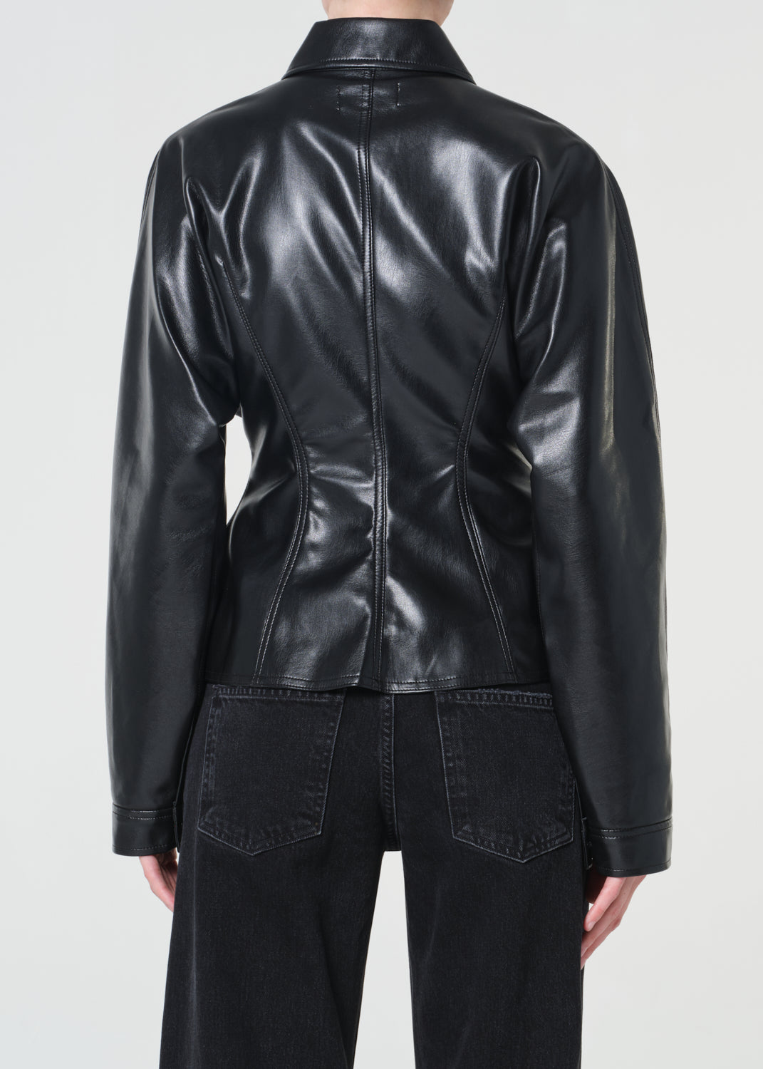 Black leather jacket worn by a person on a white background