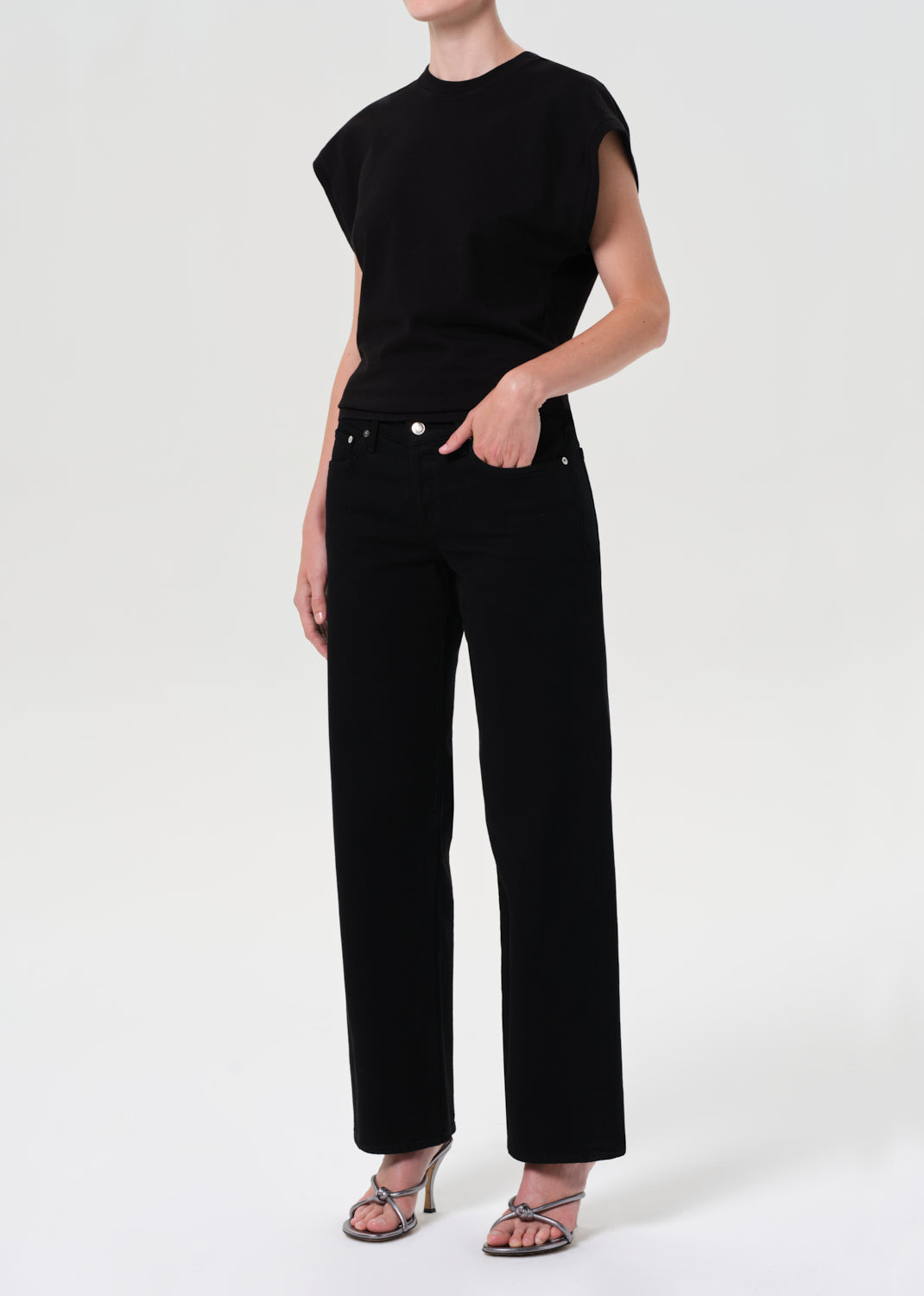 Person wearing a black outfit on a white background