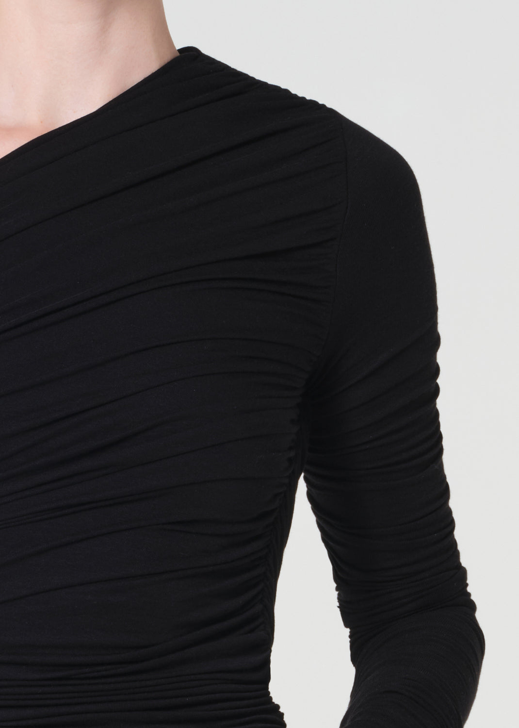 Black long-sleeve top on a plain background