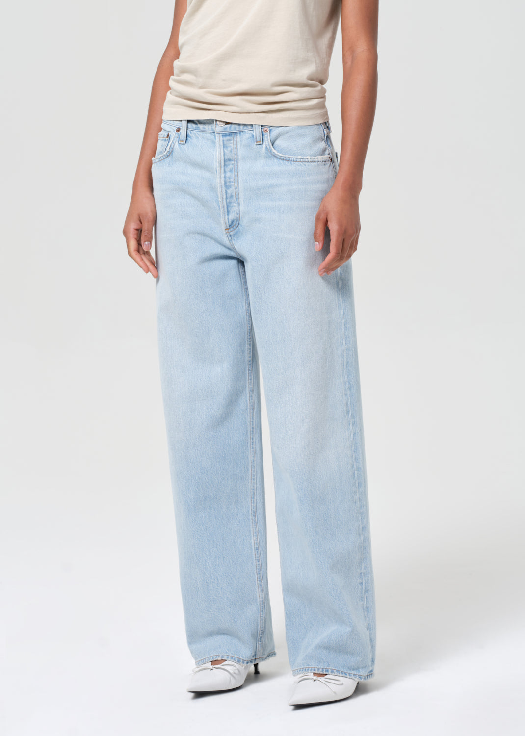 Light blue jeans worn by a person on a white background