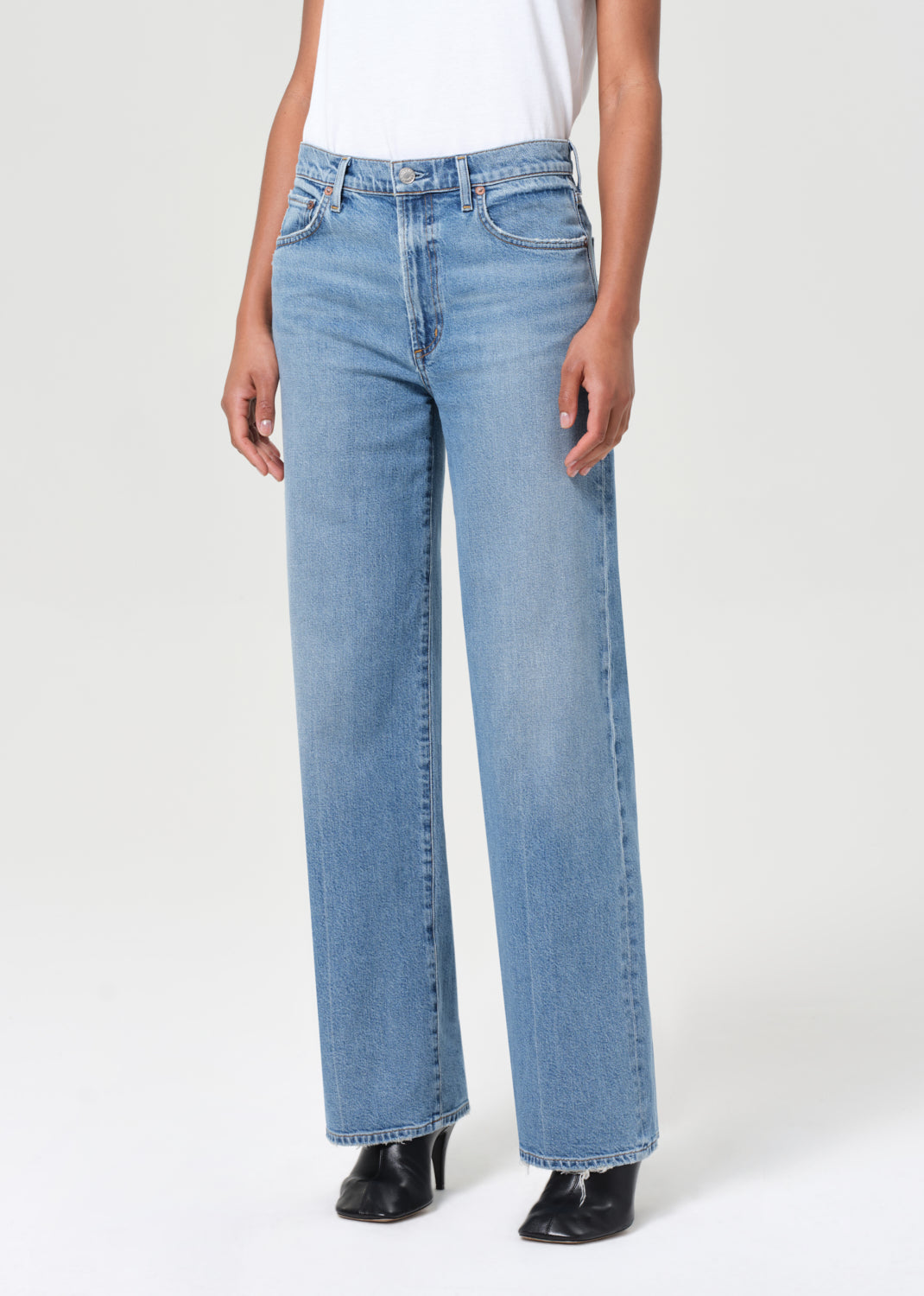 Light blue jeans worn by a person on a white background