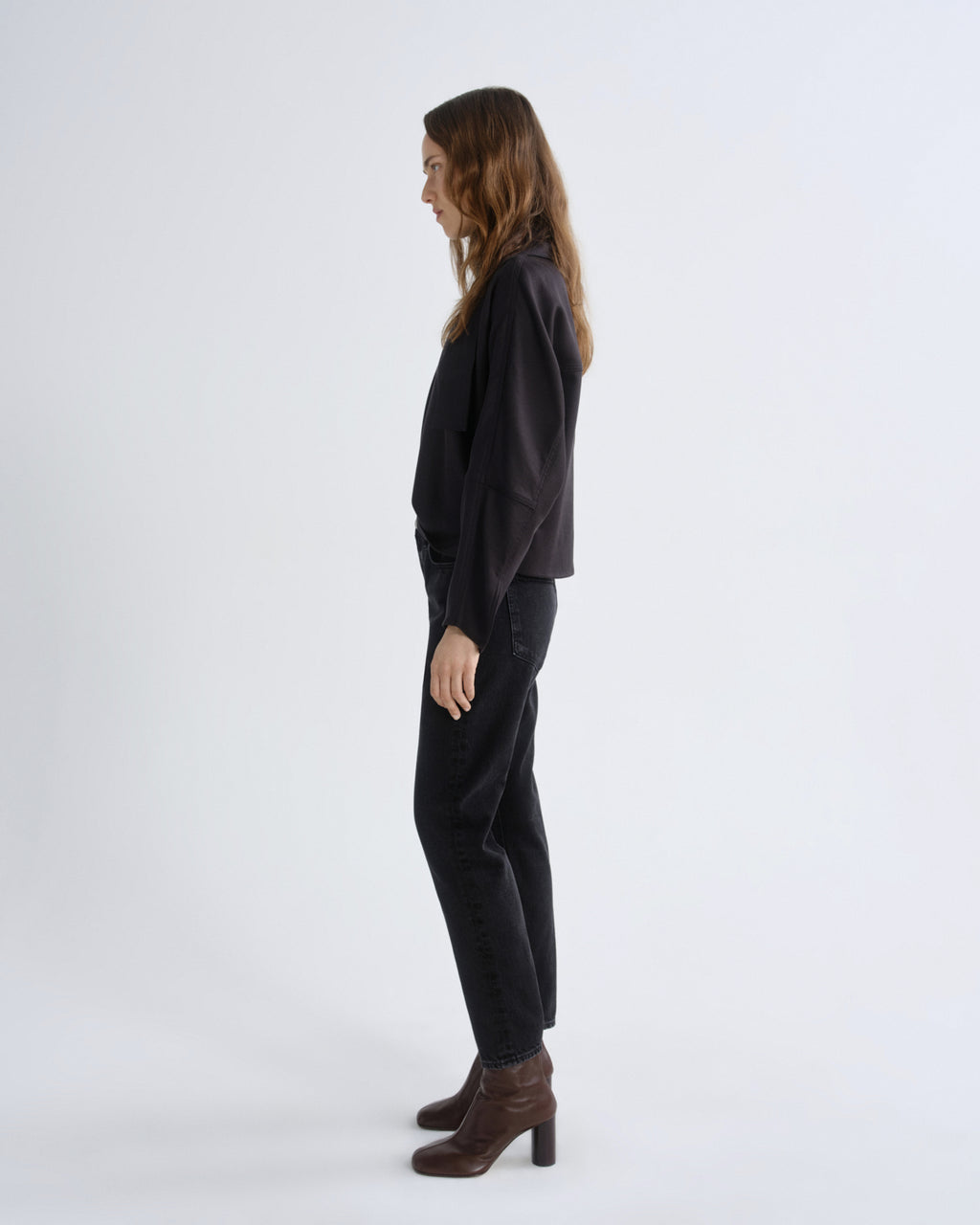 Woman wearing a black outfit on a white background