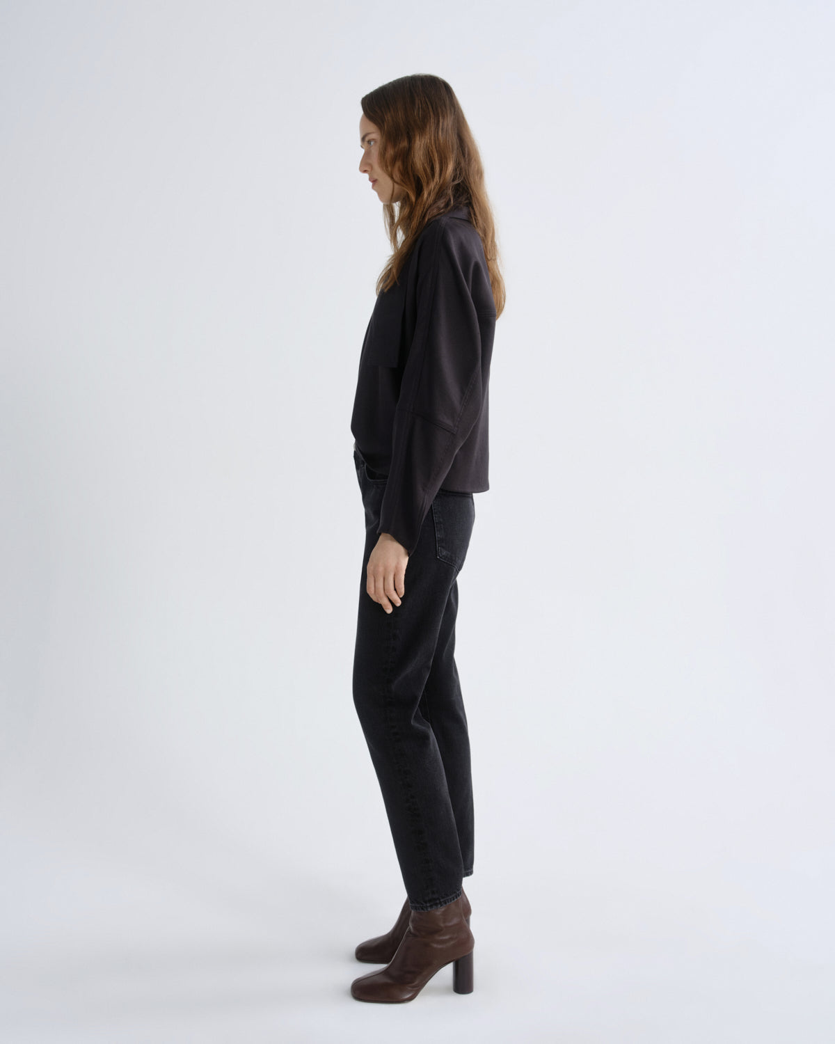 Woman wearing a black outfit on a white background