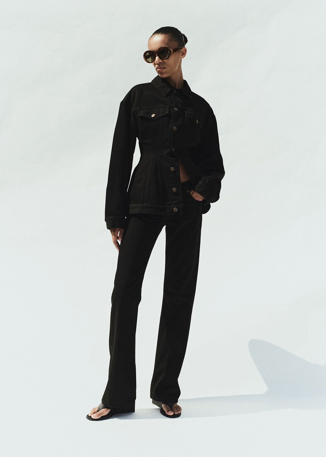 Person wearing a black outfit on a white background