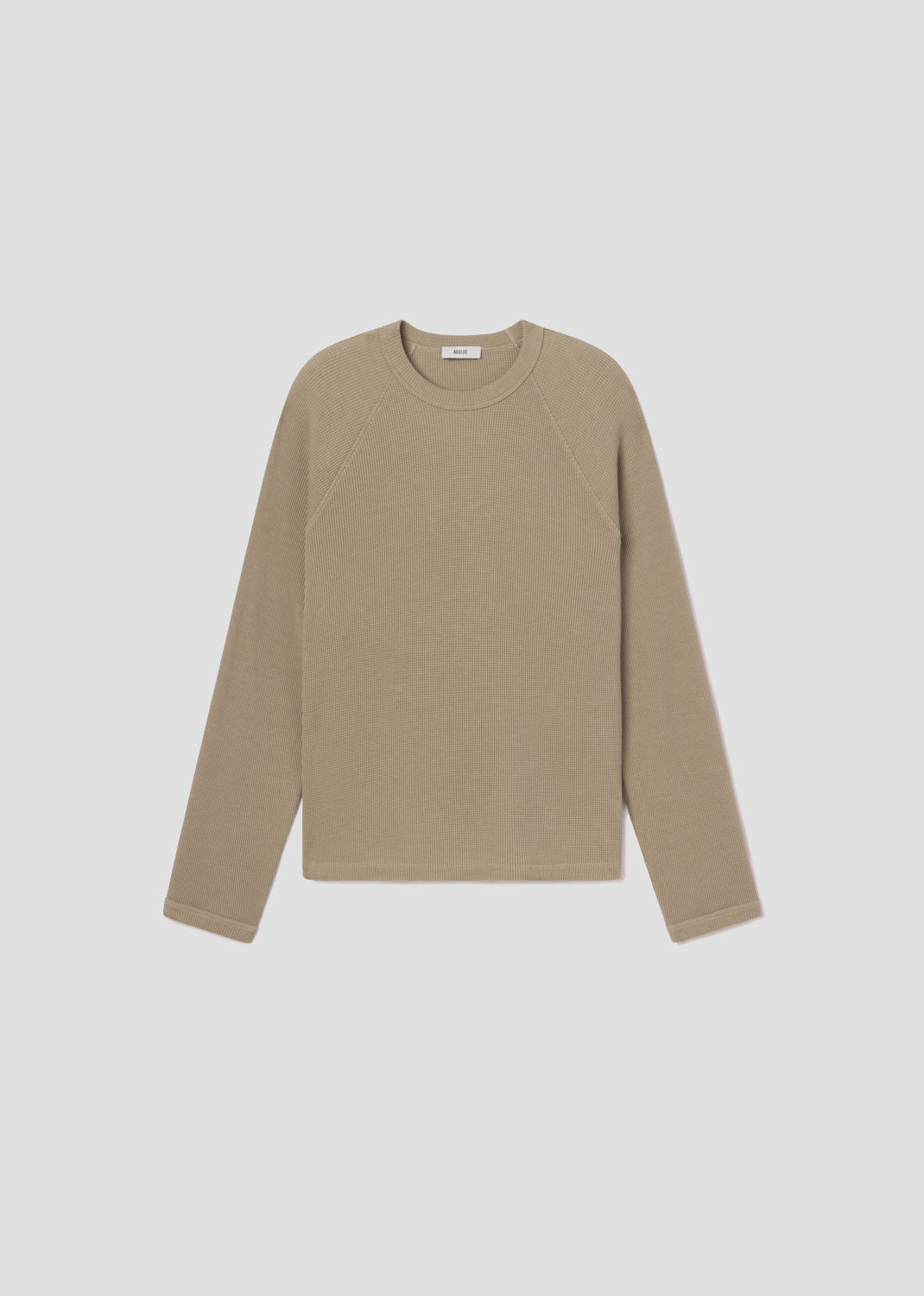 Beige long-sleeve shirt on a light gray background