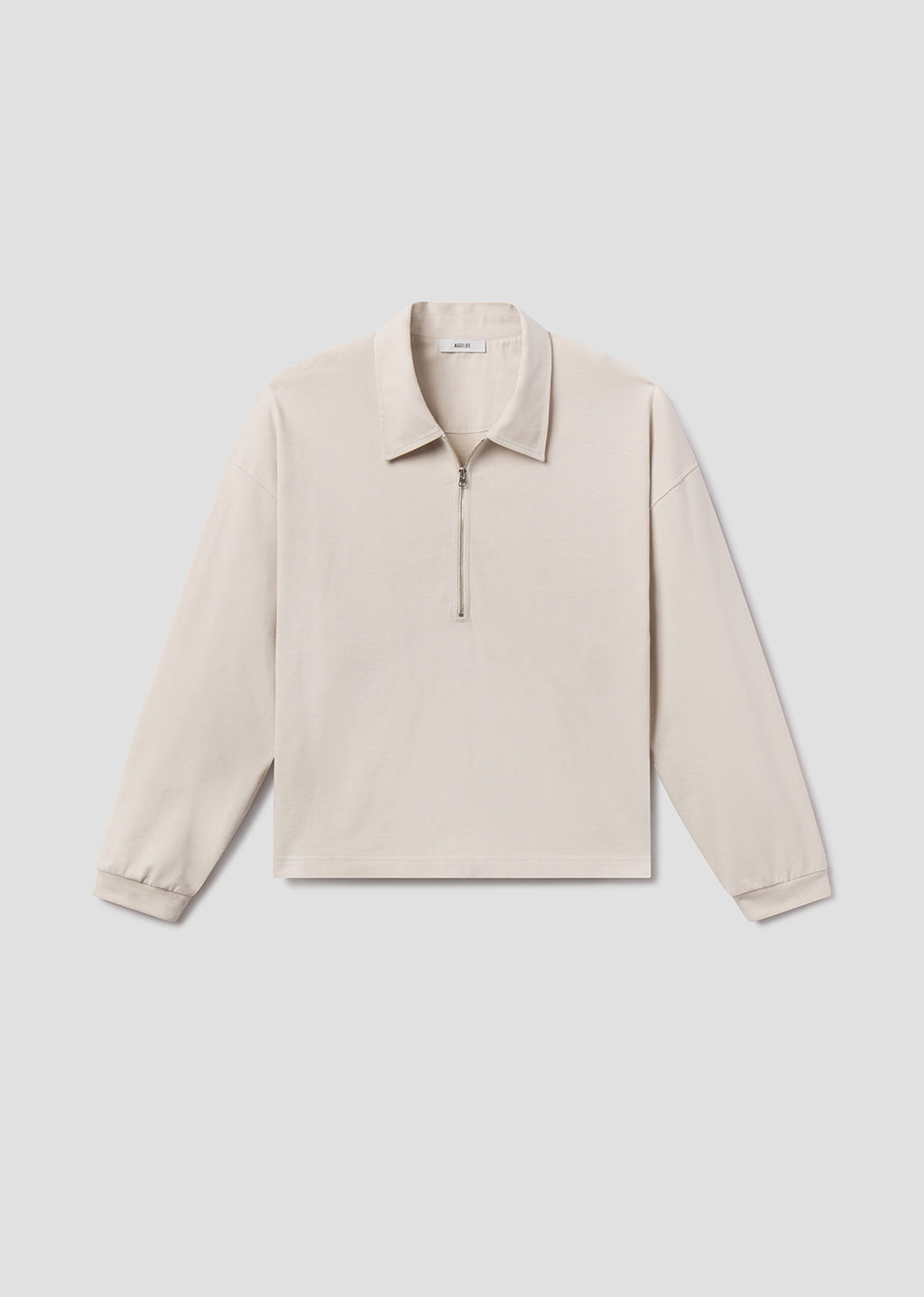 Beige long-sleeve shirt on a light gray background