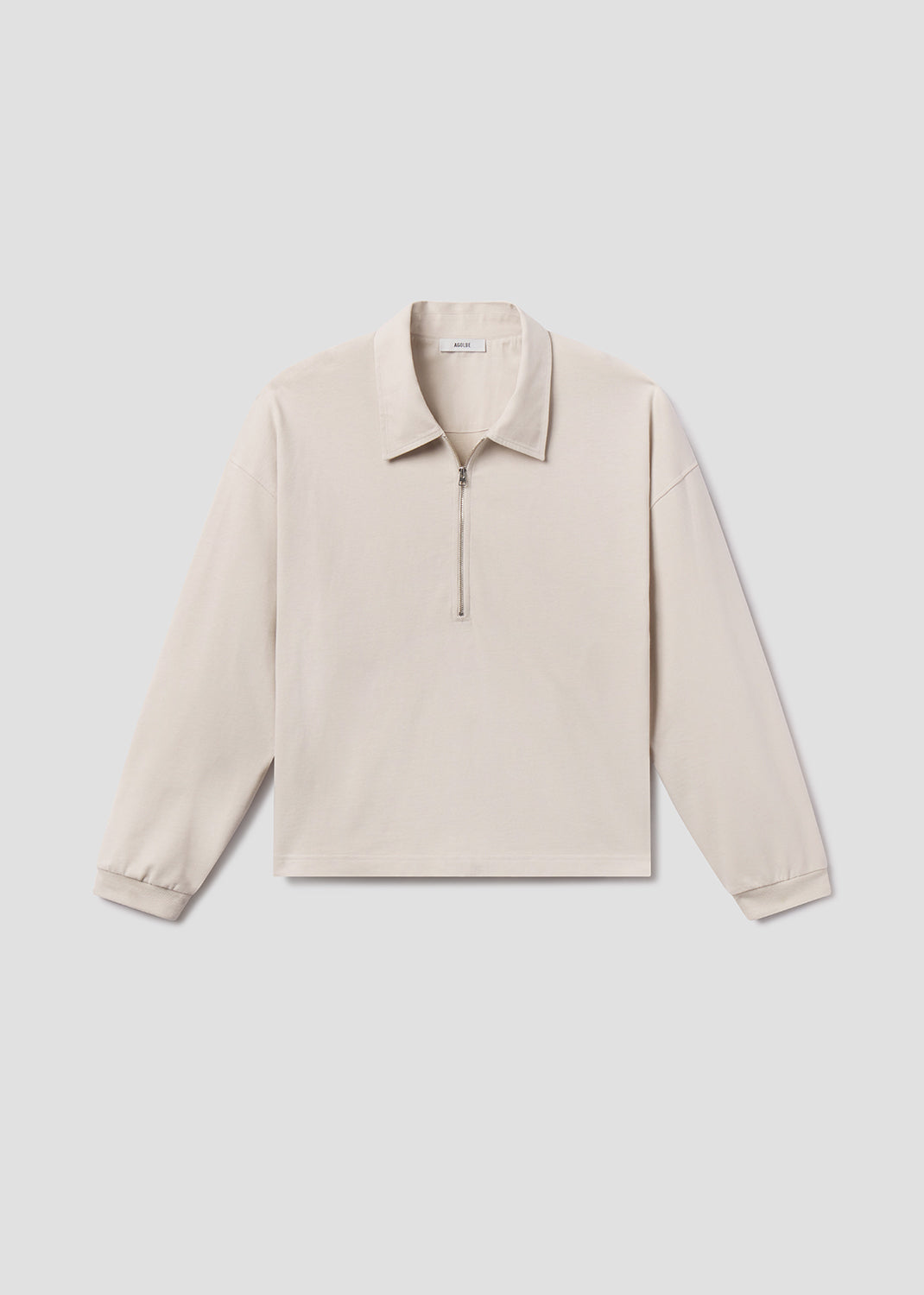 Beige long-sleeve shirt on a light gray background