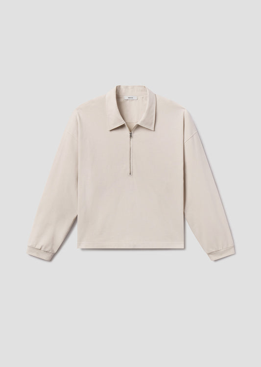 Beige long-sleeve shirt on a light gray background