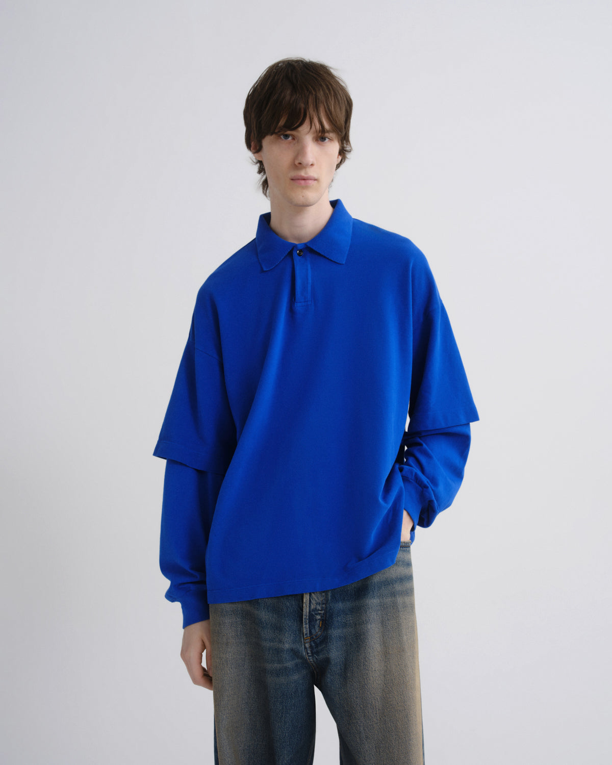 Person wearing a bright blue sweater against a plain background