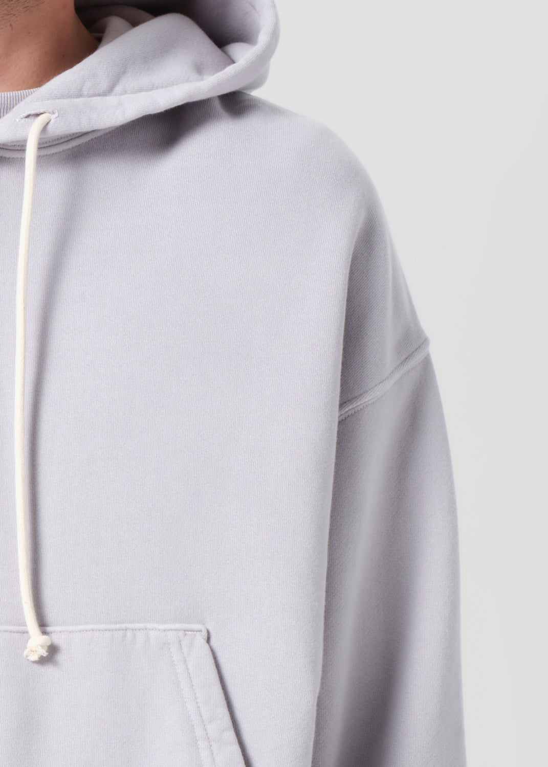 Light gray hoodie with a white drawstring on a light gray background