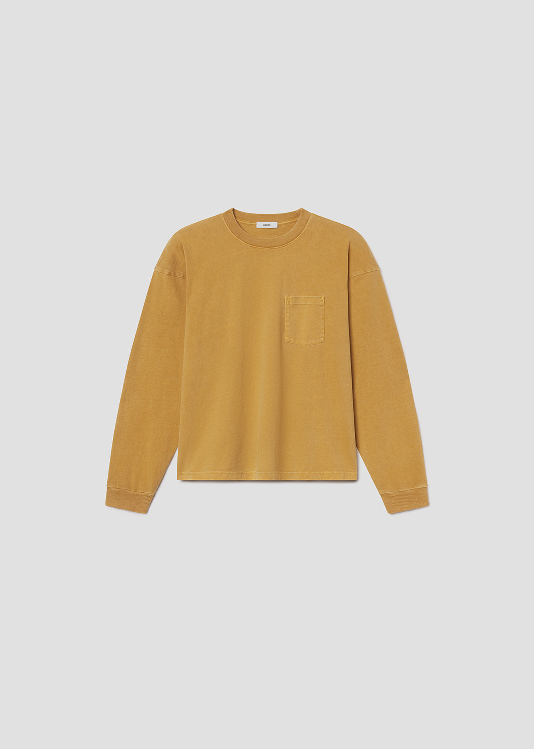 Flat lay shot of yellow shirt on grey background