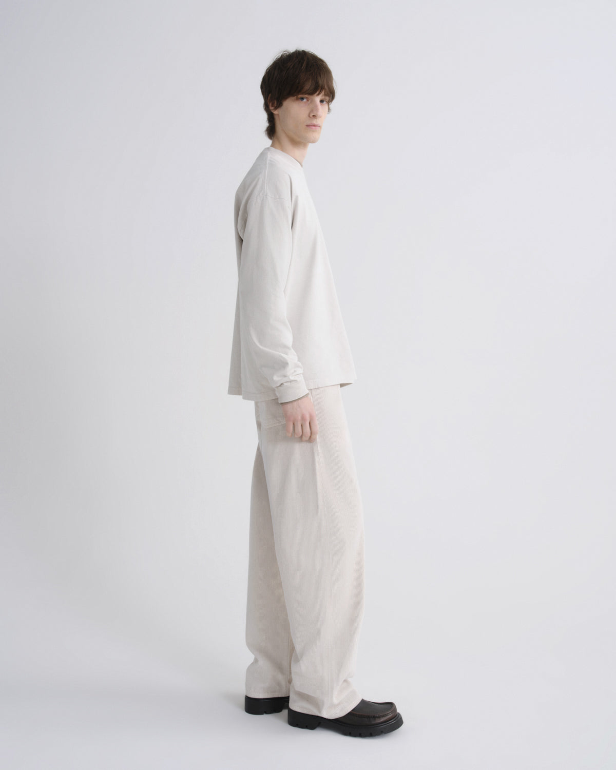 Person wearing a white outfit on a plain background