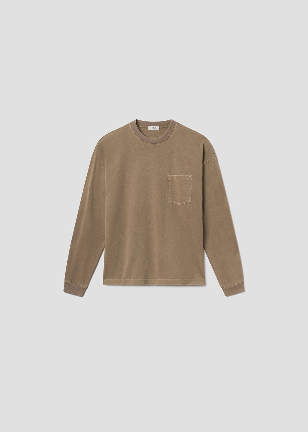 Flat lay shot of brown tee on grey background