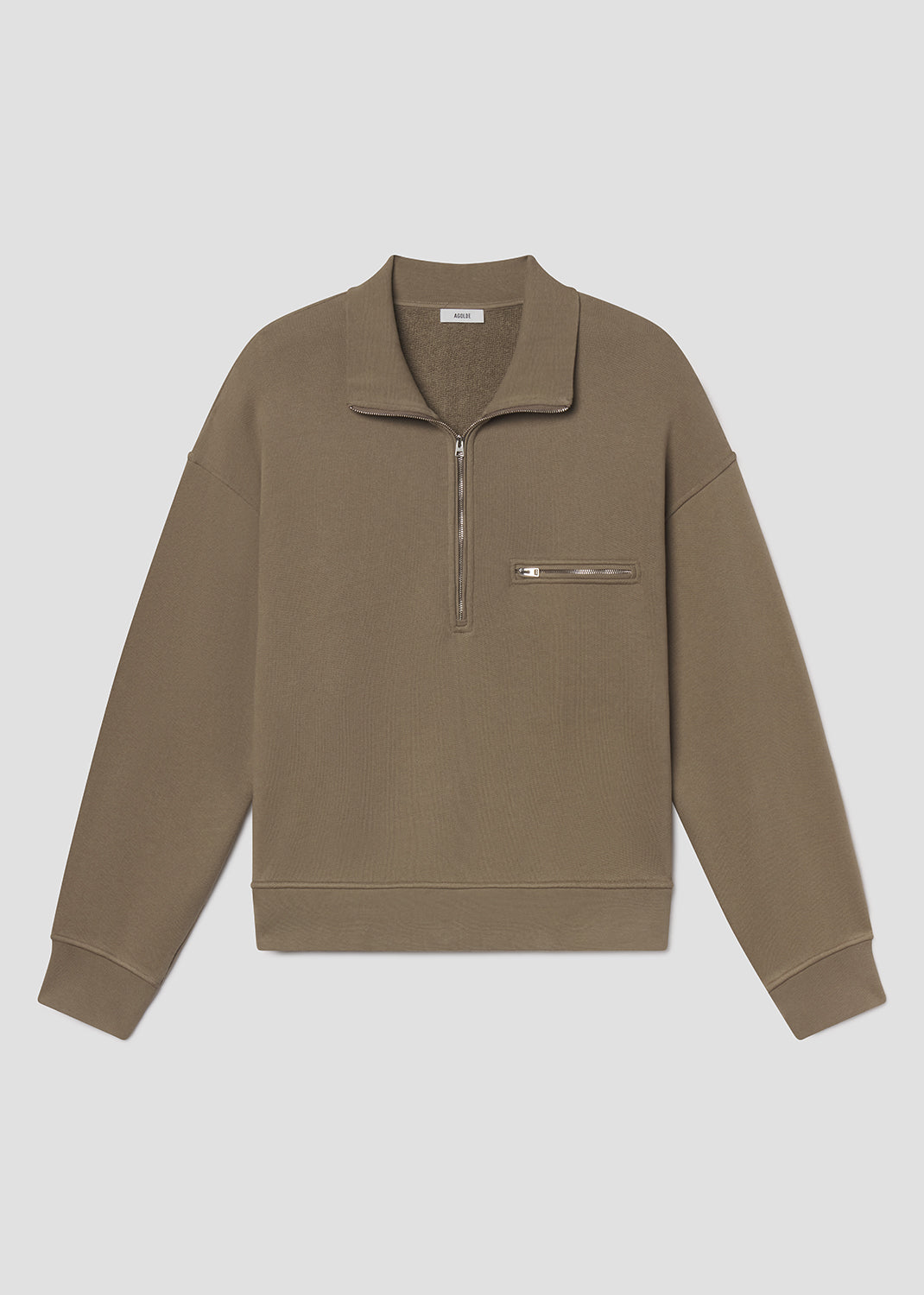 Flat lay shot of brown pullover with a zipper on a grey background