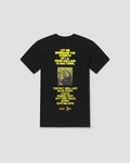 A black short-sleeve crewneck t-shirt with a yellow graphic print on the front, featuring a Bible verse and a small vintage-style photograph of a person, displayed against a neutral light gray background.