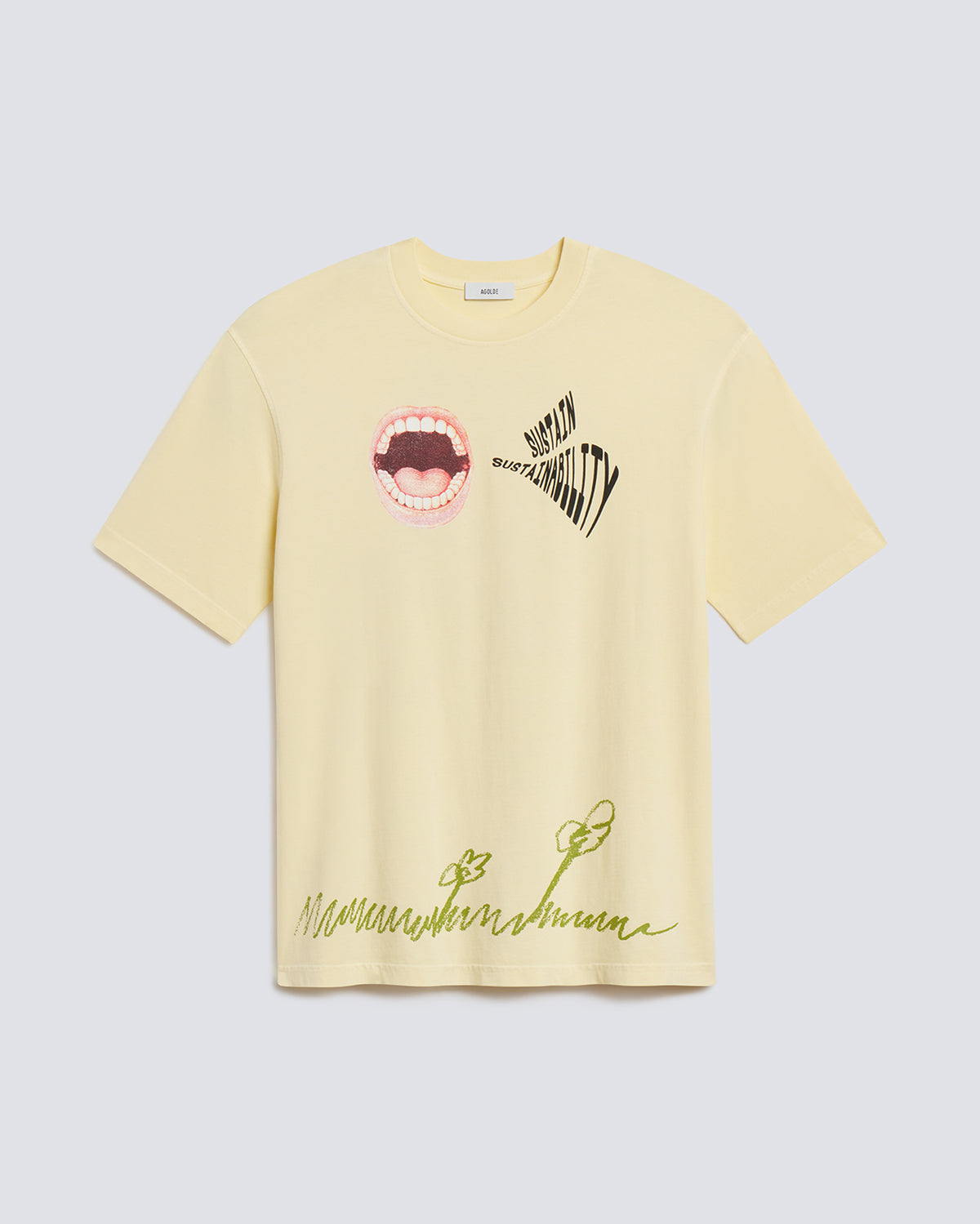 A pale yellow short-sleeve t-shirt with graphic prints, featuring a mouth graphic and the word 'MUTUAL' on the chest, and green script text near the hem, displayed on a light gray background.