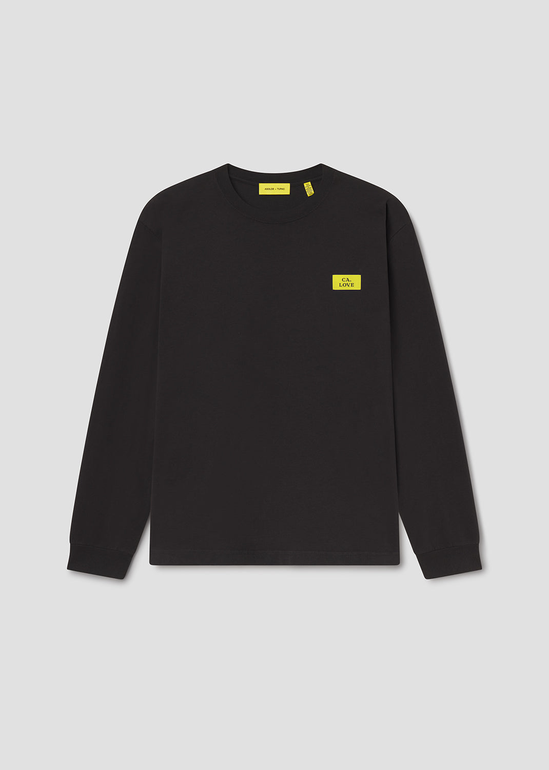 Black long-sleeve shirt with yellow labels on a light gray background