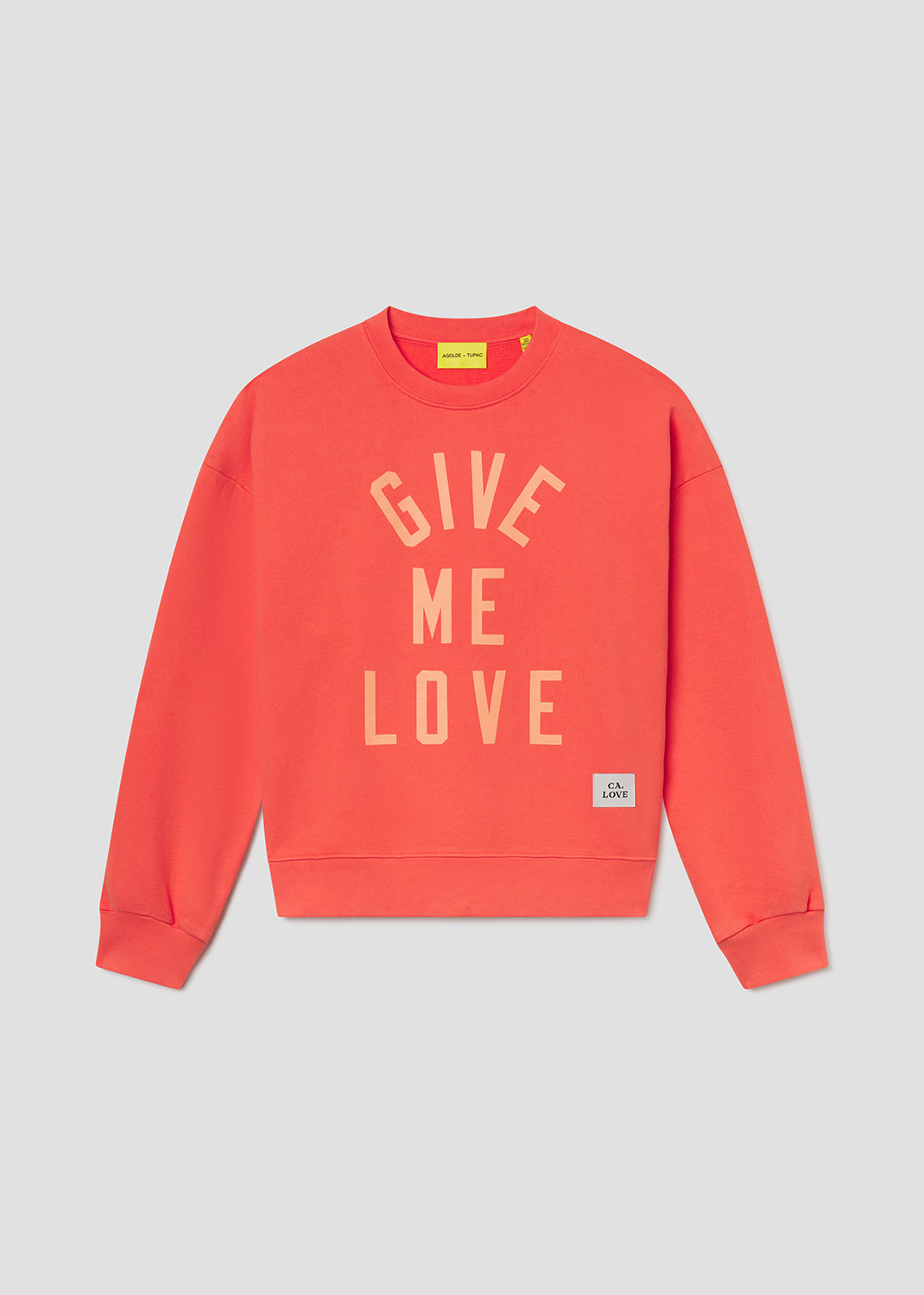Coral sweatshirt with 'Give Me Love' text on a gray background
