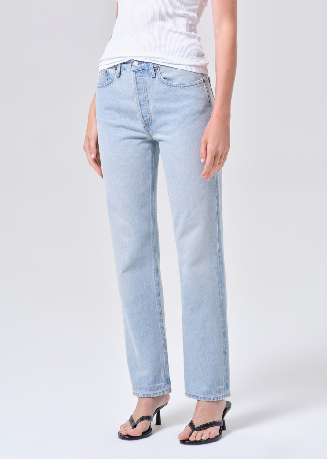 Light blue jeans worn by a person on a white background