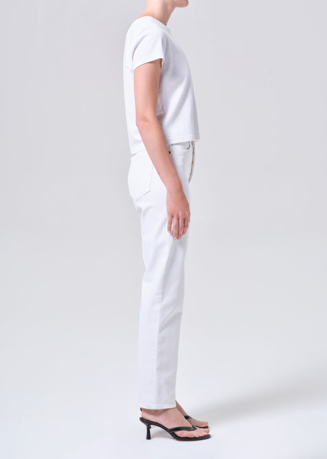 Person wearing a white outfit on a plain background