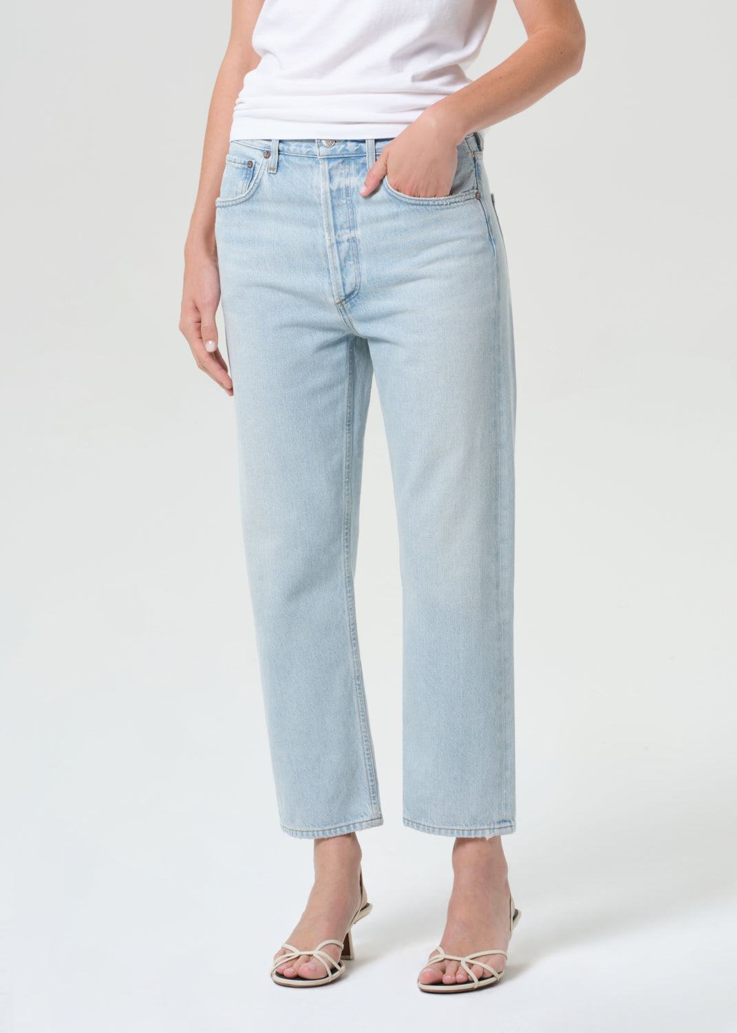 Light blue jeans worn by a person on a white background