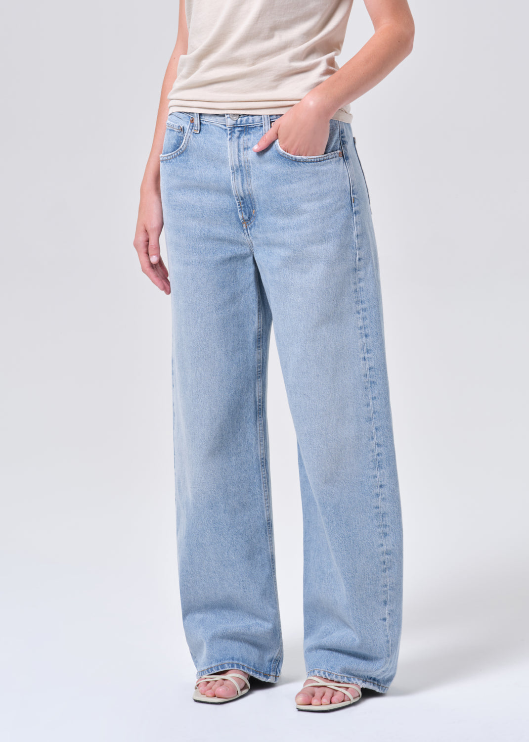 Light blue jeans worn by a person on a white background