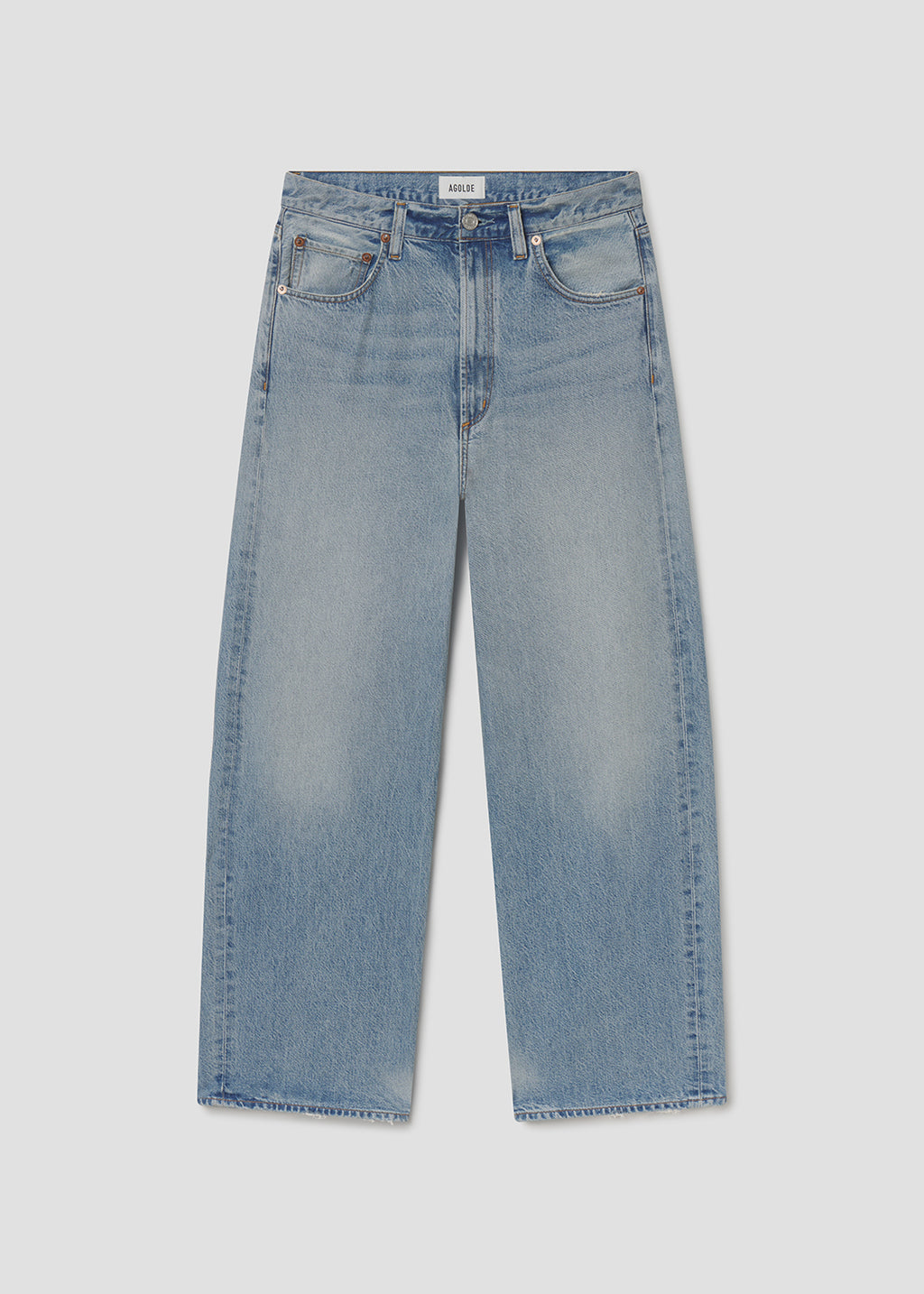 Light blue jeans on a grey background.