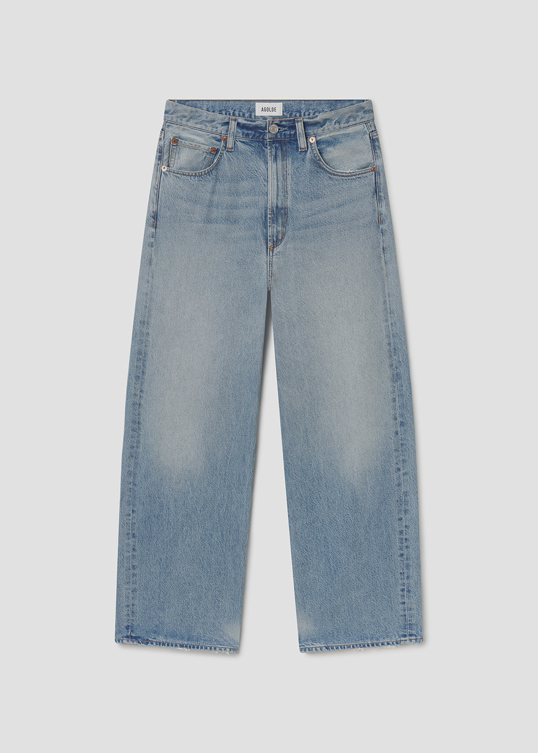 Light blue jeans on a grey background.