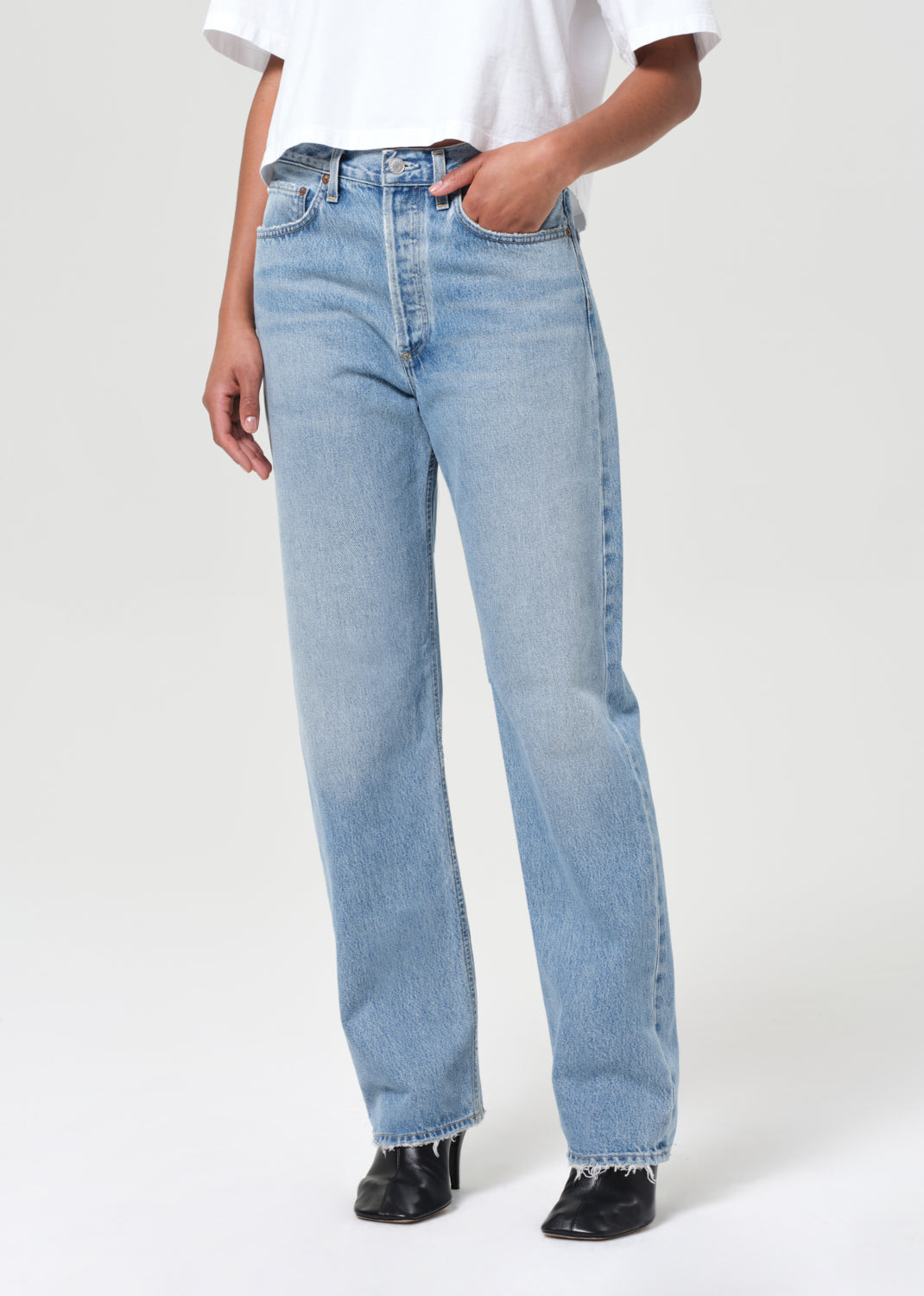 Light blue jeans worn by a person on a white background