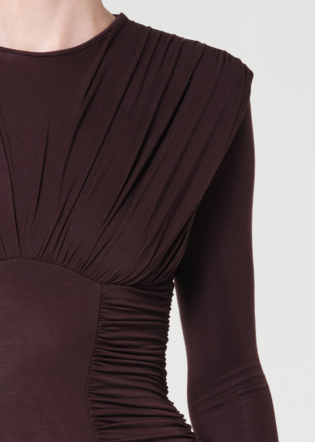 Brown long-sleeve dress with pleated design on a white background
